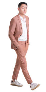 asian man in a pink suit walking