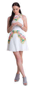 woman in a white mini dress standing