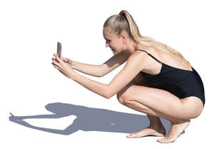 woman in a bathing suit taking a picture