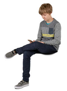 boy sitting and looking at his phone