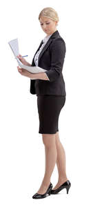 woman in an office standing and looking at papers
