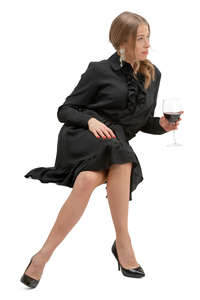 woman in a black dress drinking wine