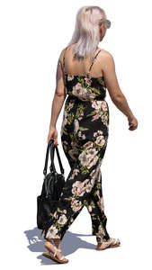 woman in a flower print jumpsuit walking