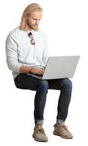 man sitting and working on his laptop