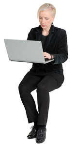 woman sitting and working on a laptop