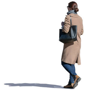 woman in a beige coat walking