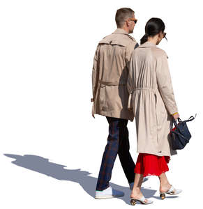 couple in brown overcoats walking