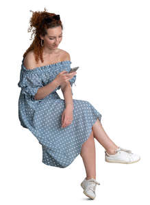 woman in a dotted summer dress sitting