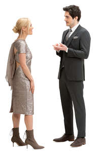 man and woman in party clothes standing and talking