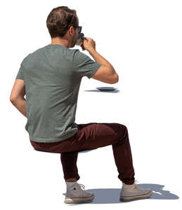 man sitting and drinking coffee on a sunny day