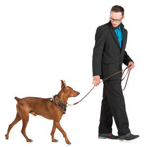 man in a suit walking a dog