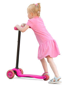 little girl in a pink dress riding a scooter