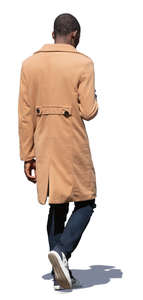 black man in a beige coat walking
