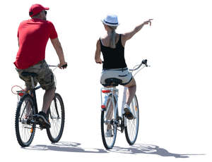 backlit man and woman biking