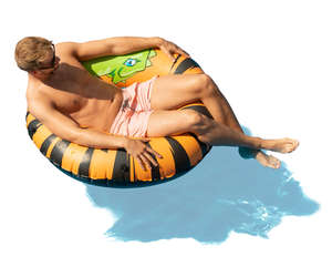 man sunbathing in a large swim ring