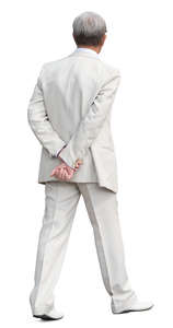man in a white suit walking