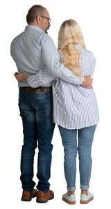 elderly couple standing with arms around each other