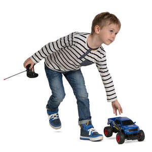 little boy playing with a toy car