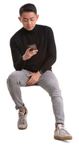 asian man sitting and texting