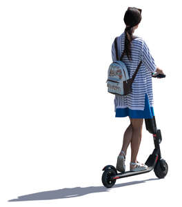 young backlit woman riding an electrical scooter