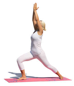 woman in a white sports outfit doing yoga