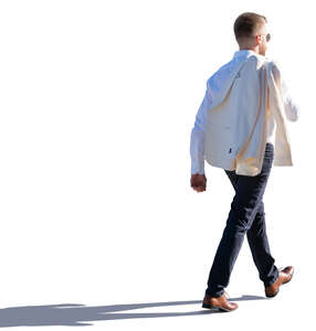 backlit man walking with a jacket over his shoulder