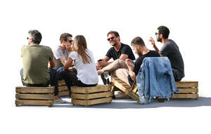 six people sitting in a park cafe and talking