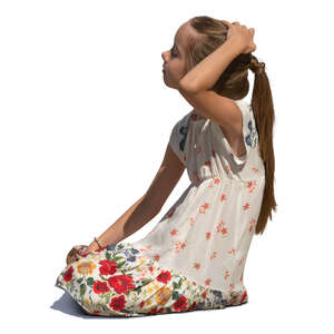 little girl kneeling on the ground
