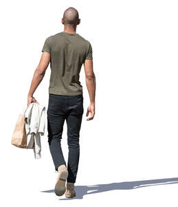 man with a small shopping bag walking
