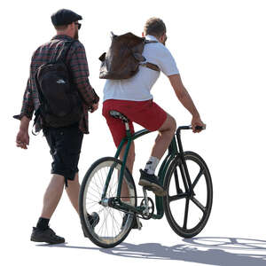 two men talking while one rides a bike