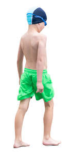 boy in swimming trunks walking