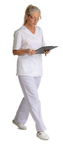 older nurse with some papers walking