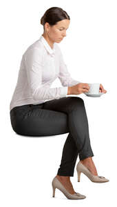 woman sitting and having a cup of coffee