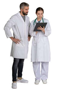 two doctors standing and looking at papers