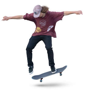 teenage boy doing a stunt on a skateboard