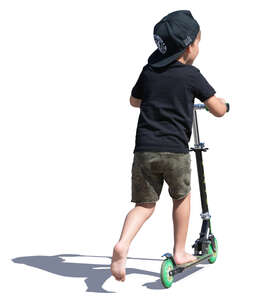 little boy with a hat riding a scooter