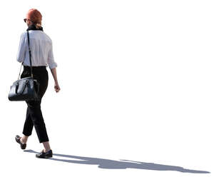 backlit woman walking on a street