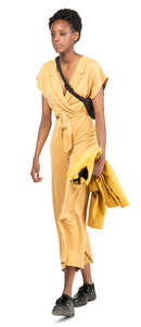 woman in a yellow jumpsuit walking