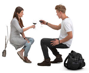 man and woman sitting and drinking wine