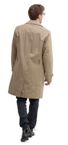 man in a trenchcoat walking