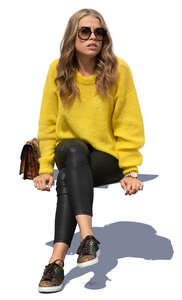 woman in a yellow knit sweater sitting