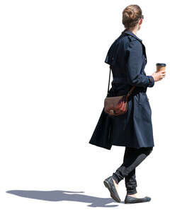 woman in a blue overcoat drinking coffee on the go