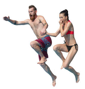 man and woman jumping into the pool together