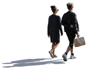 young backlit man and woman with a shopping bag