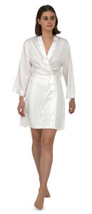 woman in a white silk bathrobe walking