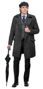 man in a grey overcoat and umbrella standing