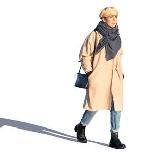woman in a beige overcoat walking