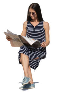 woman sitting and reading a newspaper