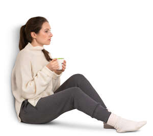 woman with a coffee mug sitting by the window