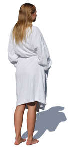 woman in a white bathrobe standing